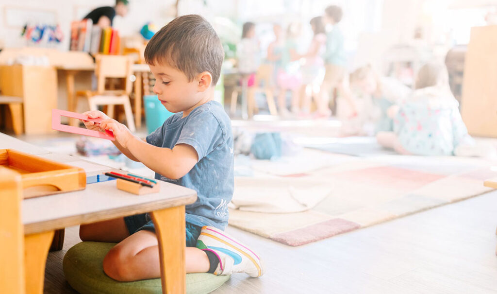Boy Learning Montessori Principles