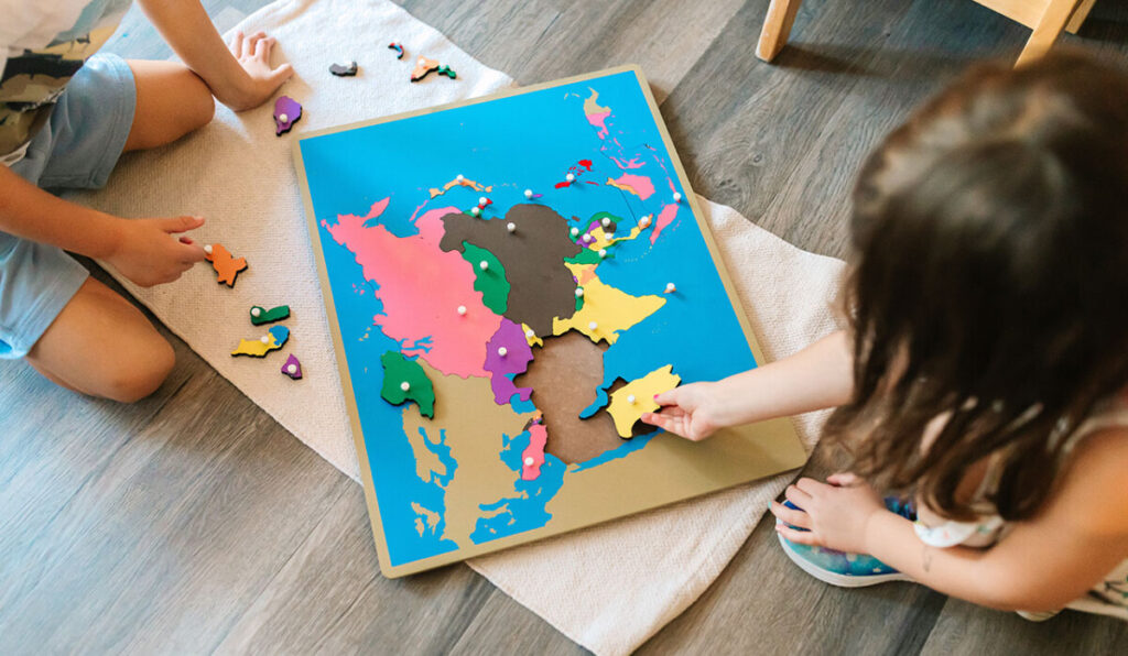 Montessori student working on the world map