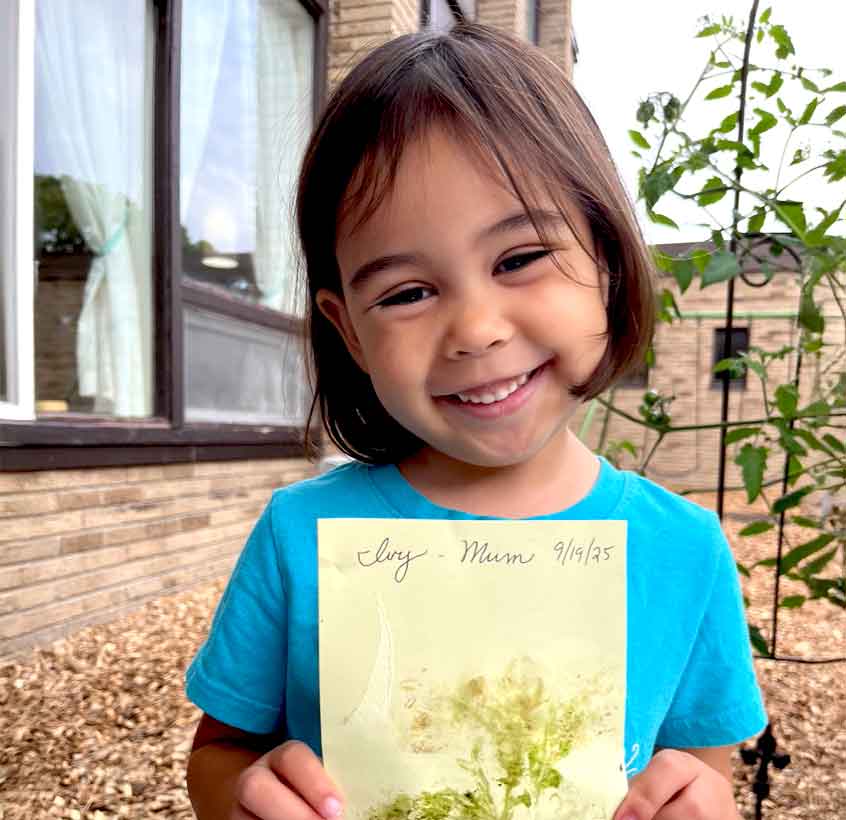 Little girl holding a picture she created.